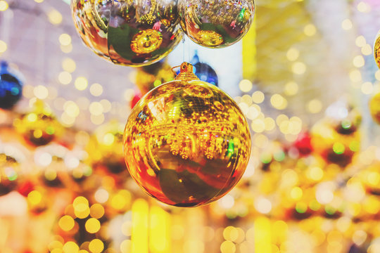 Decorated festival with gold ball. Orange, yellow and white bokeh light at Festival. Abstract or blurred of light glitter. Glow texture background.
