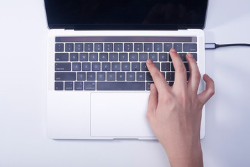 Woman hand pressing keyboard shortcut on laptop keyboard