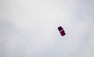 silhouette parachute stunt unfocused and blurry while gliding in the air