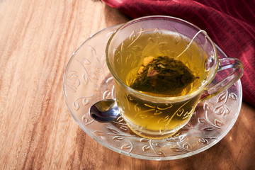 A cup of peach oolong green tea brewed with a tea bag