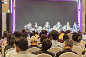 Rear view of Asian audience joining and listening group of speaker talking on the stage in the...
