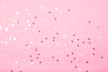 Little snowflakes confetti on pink background
