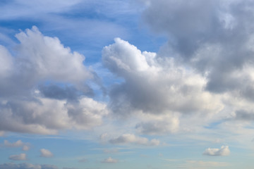 Obraz premium Cloudy sky with a parts of clear blue sky on a sunset. Natural background.