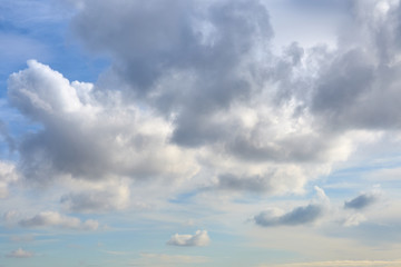 Fototapeta premium Cloudy sky with a parts of clear blue sky on a sunset. Natural background.