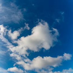 Fantastic clouds against blue sky, square