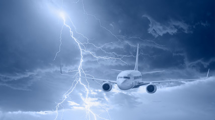 Naklejka na ściany i meble Airplane flying in a thunder and lightnings 