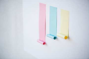 Colorful chart made up of blank pink and smaller blue and yellow sticky papers
