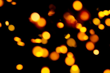 Obraz premium Black background with bright warm bokeh lights. Holiday, Christmas and New Year background. Ideal to layer with any design. Horizontal