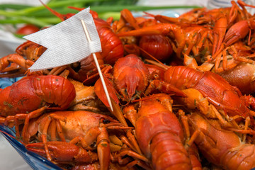 Crayfish boiled on a plate show a white flag