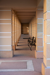 covered walkway lined with large square brick columns