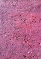 Bright fuchsia textured background. Cement surface with cracks and scratches painted with pink paint. Close-up, top view, vertical, plenty of free space for text.