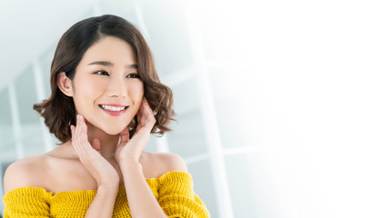 Portrait of beauty asian woman applying lotion to her arm skin during her morning routine. Cute...