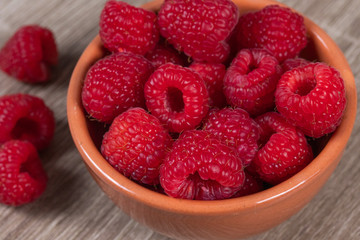 dish of fresh raspberries on a table