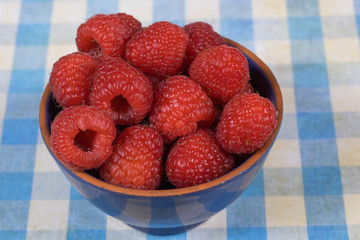 dish of fresh raspberries on a table