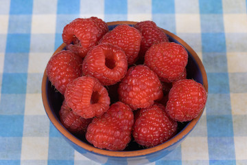 dish of fresh raspberries on a table