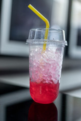 Glasses of sweet water red soda with ice cubes.