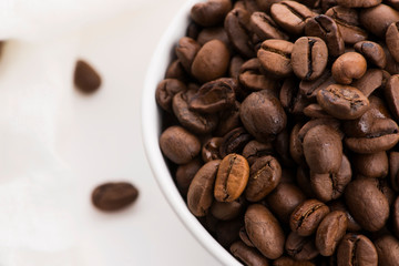 Bowl of caffee beans on a white background