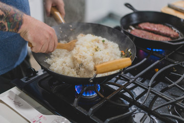 chef frying rice in a wok