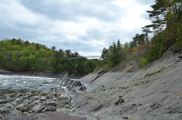 Fototapeta na wymiar river in Canada with rocks and trees and bridge