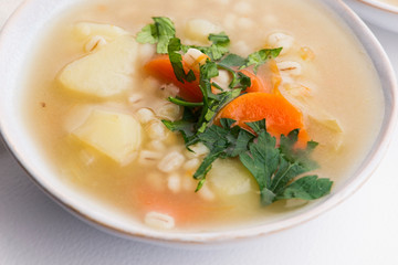 Barley soup, pearl barley in white bowl