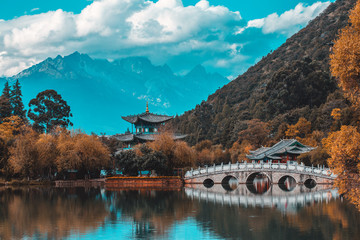 Beautiful view of the Jade Dragon Snow Mountain and the Suocui Bridge over the Black Dragon Pool in...