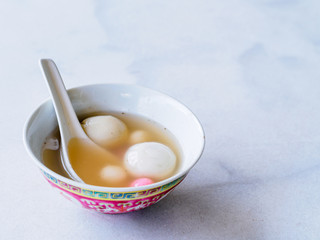 Bowl of tangyuan / tang yuan, a traditional Chinese desert of glutinous rice flour balls in a sweet soup eaten on the Dongzhi and Yuanxiao festivals