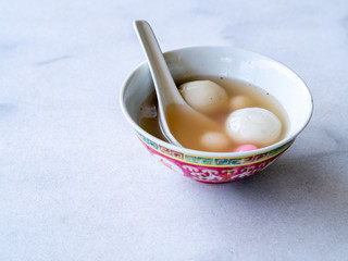 Bowl of tangyuan / tang yuan, a traditional Chinese desert of glutinous rice flour balls in a sweet soup eaten on the Dongzhi and Yuanxiao festivals