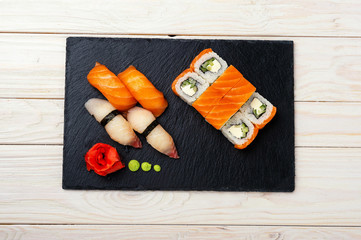 fresh sashimi with green on wooden table