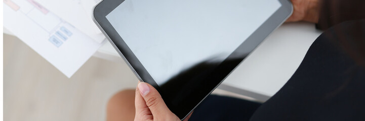 businesswoman study documents hold tablet in her hands closeup