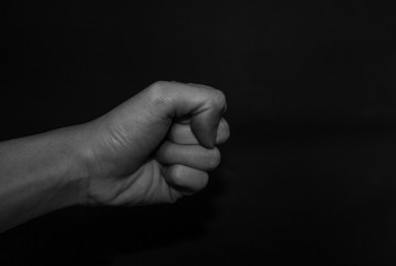 Monochrome hand gestures on black background