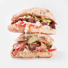 A two piece steak sandwich