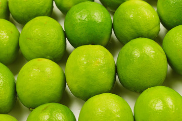 Many fresh limes on white background.