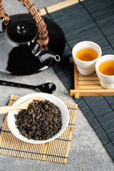Hot tea in glass teapot and cup with steam