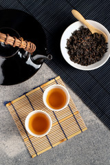 Hot tea in glass teapot and cup with steam