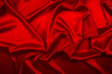Obraz premium Red silk or satin luxury fabric texture can use as abstract background. Top view.
