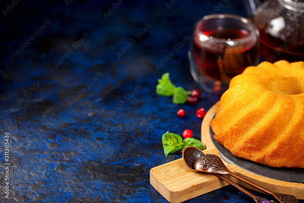 Wall mural Biscuit cake with icing sugar, a cranberry and mint