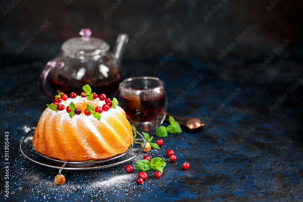 Wall mural Biscuit cake with icing sugar, a cranberry and mint