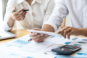 Two business teamwork calculating a valuation in workplace.
