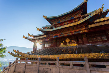 Fototapeta premium Guishan temple with giant buddhist tibetan prayer golden wheel in old town Shangri la