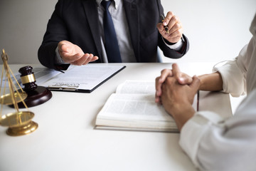 Lawyer and client with legal contract signing in law firm.