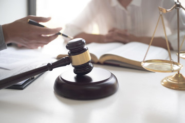Lawyer and client with legal contract signing in law firm.