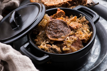Traditional polish sauerkraut (bigos) with mushrooms and plums for christmas