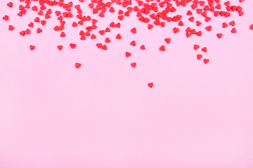 Pink background with red hearts. Valentine's day concept. Top view. Copy space for text.
