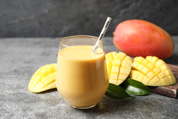 Fresh delicious mango drink on grey table