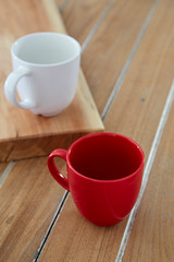 Two red and white mug coffee on wooden