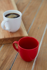 Two red and white mug coffee on wooden
