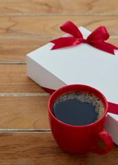 one Red mug coffee and Gift box on wooden