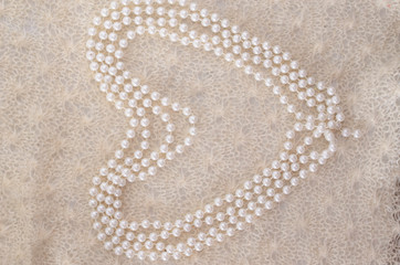 Fototapeta na wymiar White pearls on a shawl, a warm, homely atmosphere