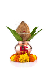 Copper Kalash with coconut and mango leaf and pooja thali with diya, kumkum and sweets with floral...