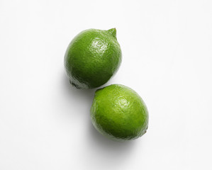 Fresh juicy limes on white background, top view